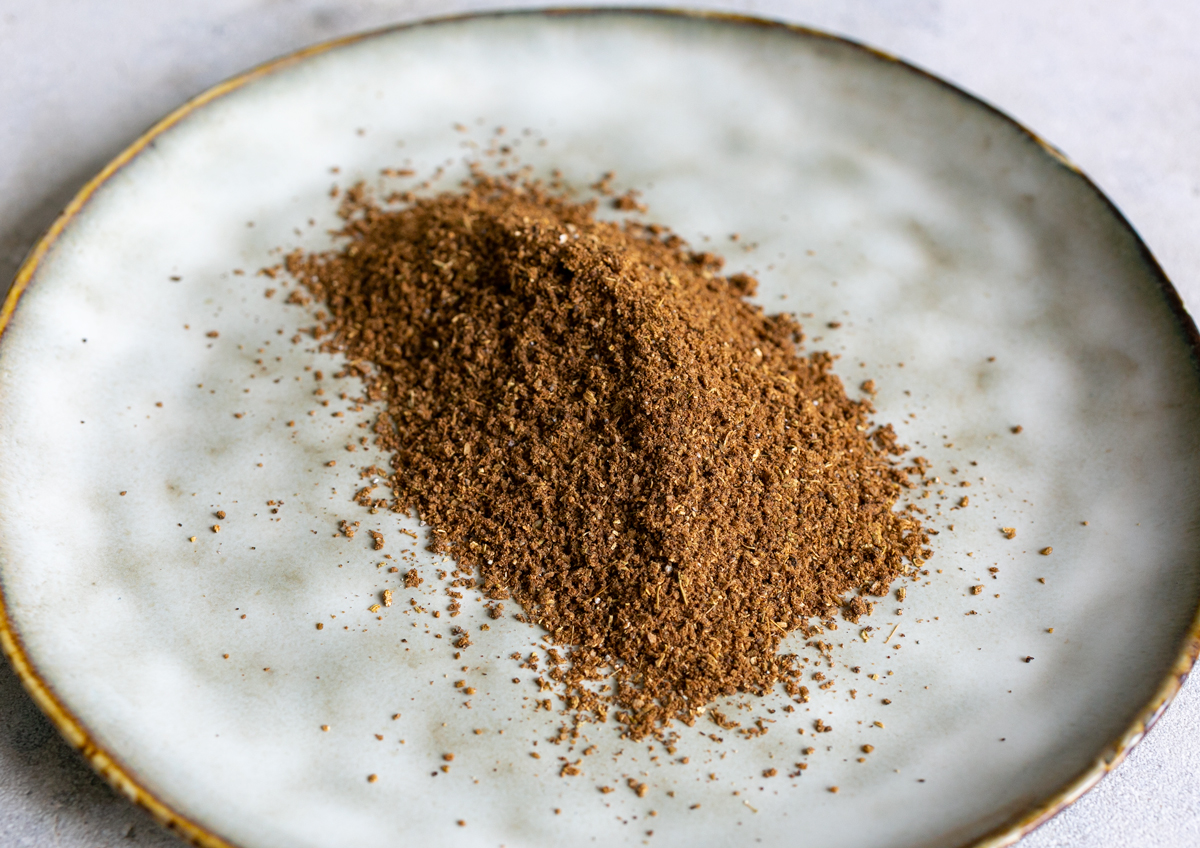 a large amount of baharat spice blend on a grey plate