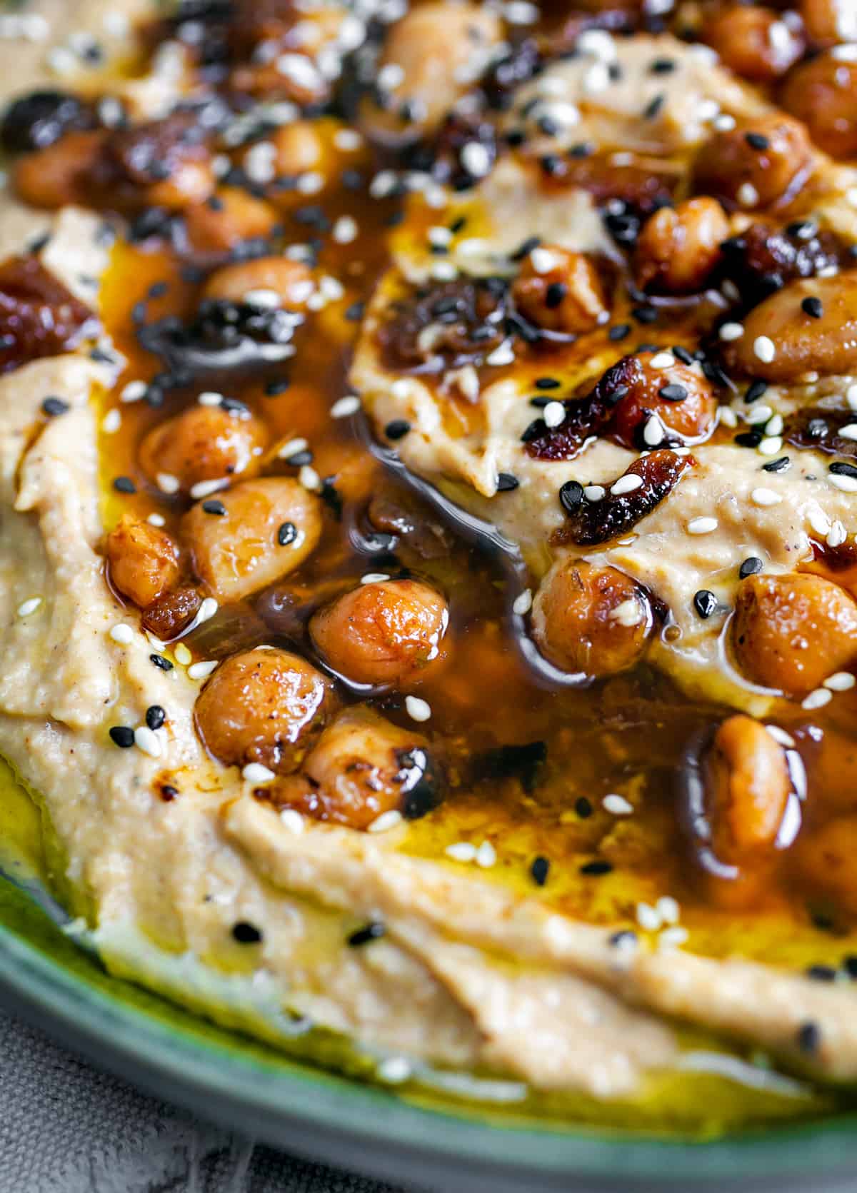 Hummus topped with beans, onions and oil