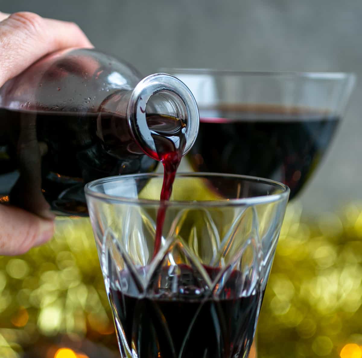 Festive mulled wine being poured into a crystal glass