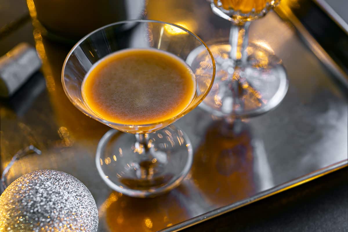 a glass of Salted Caramel Whisky on a silver serving tray