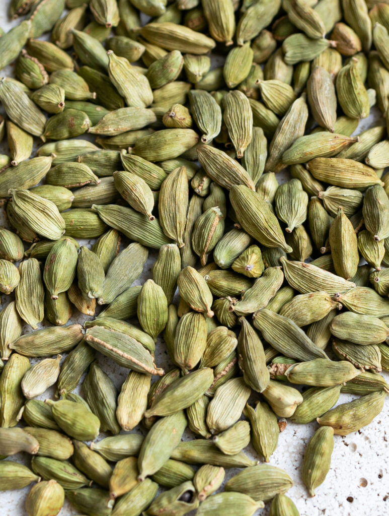 close up of lots of green cardamom pods