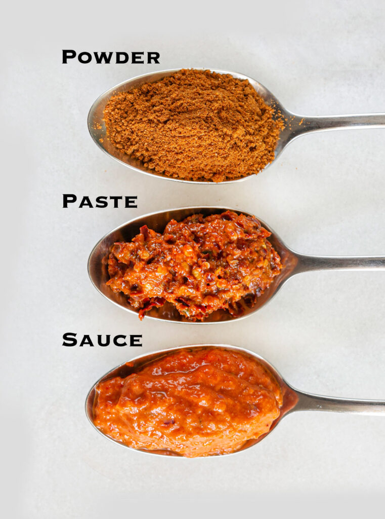 3 spoons each containing one type of harissa. Harissa powder, harissa paste and harissa sauce.