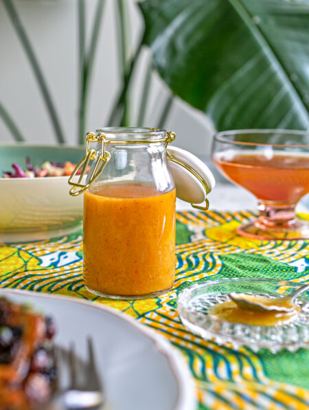 Sauce jar containing orange habanero mango hot sauce