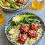 blue ceramic bowls filled with Gochujang Meatballs and Egg Rice and beers