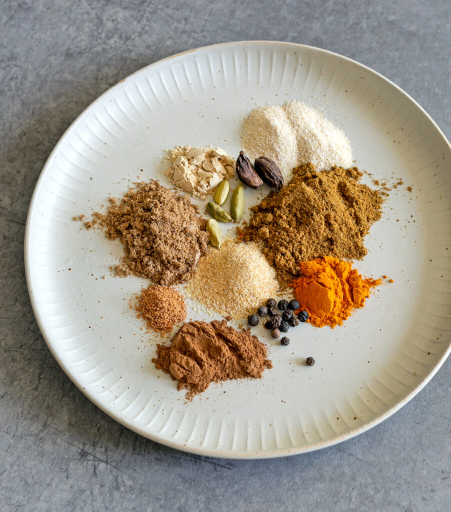 A beige ceramic plate with shawarma spices ready to be blended