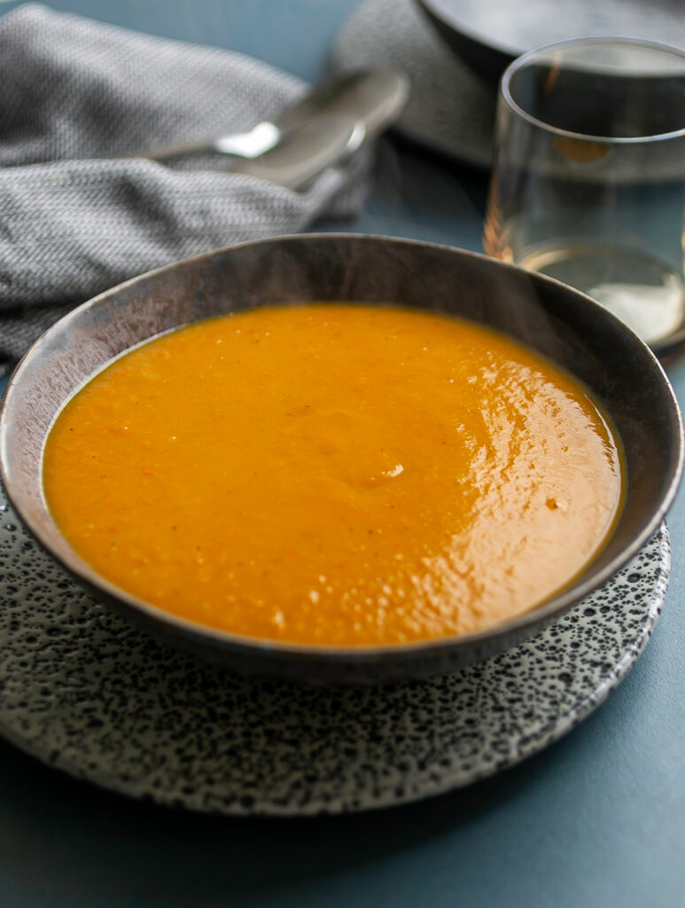 dark ceramic bowl filled with pumpkin soup 