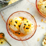 Pink glass bowl filled with Passion Fruit No Churn Ice Cream