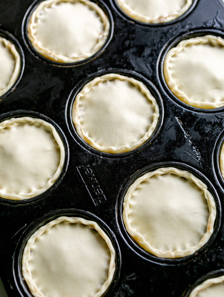 Muffin tin filled with Mini Beef Brisket Pies