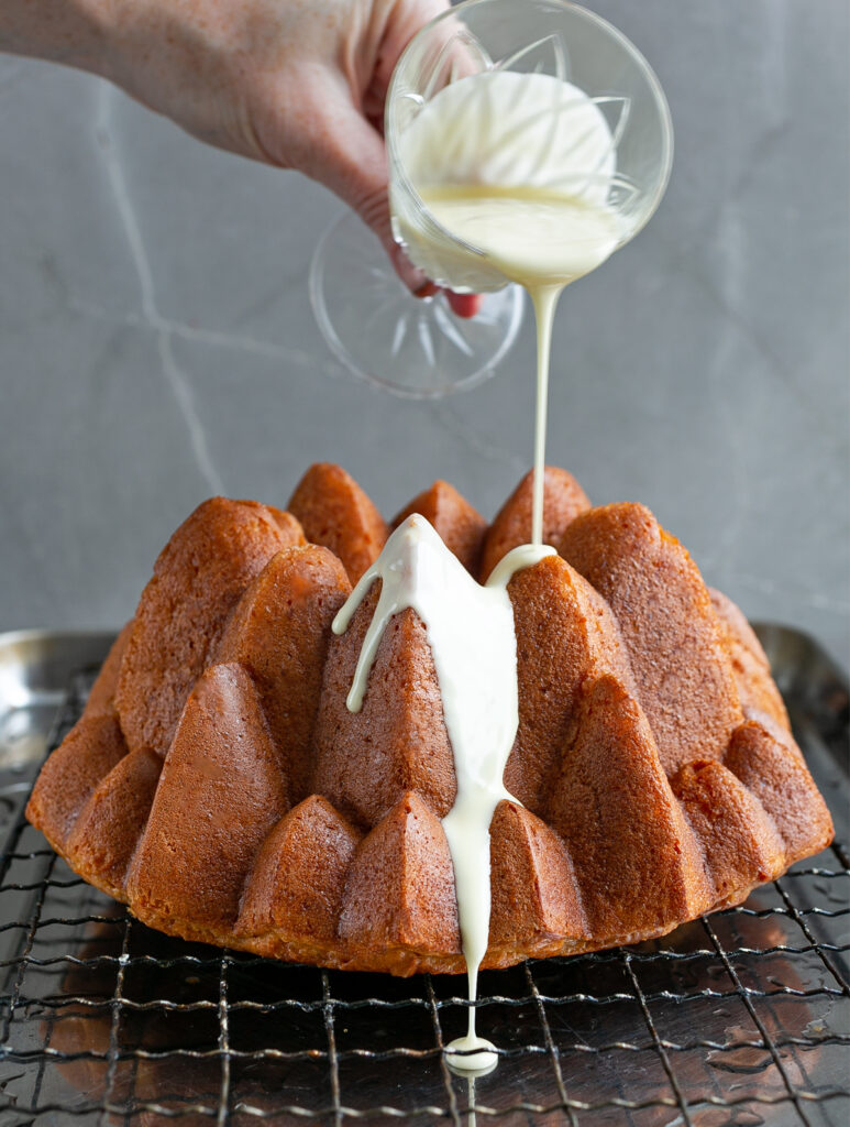 White Chocolate being poured over a Rum Baba Bundt Cake